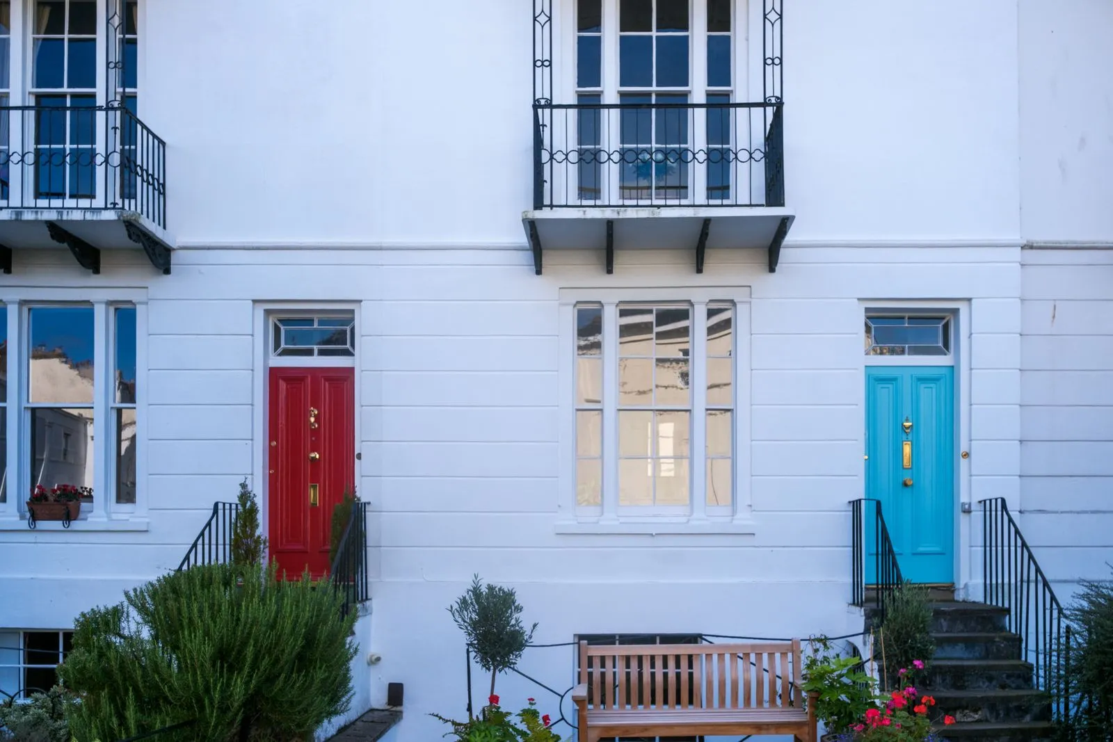 Charming townhouses in Bristol with distinctive red and turquoise doors, perfect for urban living inspiration.